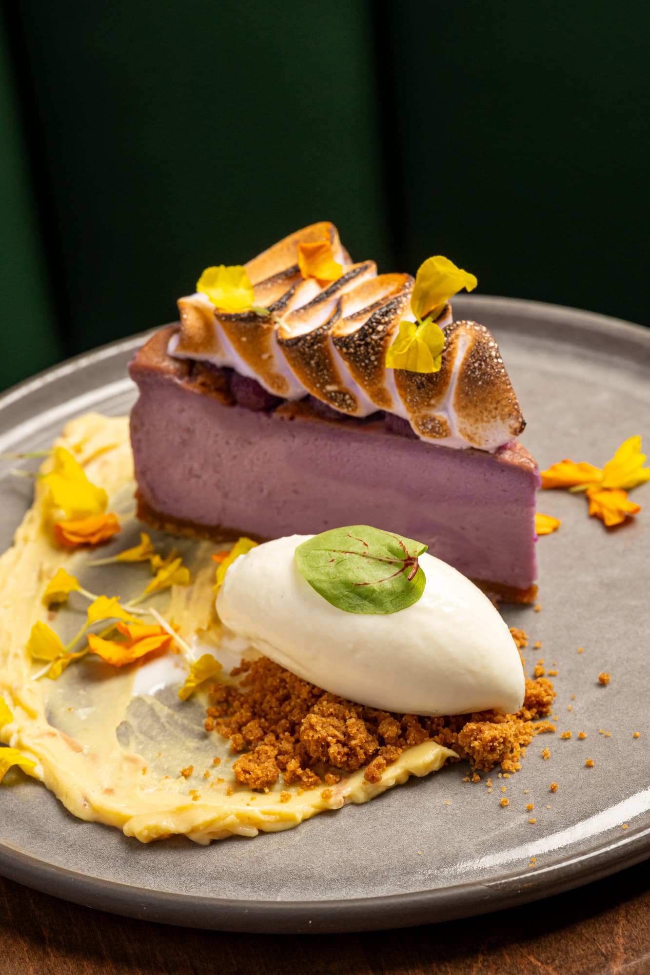 Ube cheesecake with meringue and edible flowers at The Berczy Tavern
